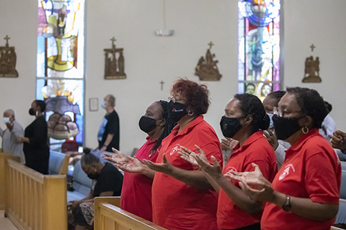 Faithful gathered at St. Bartholomew Church in Miramar pray during the Mass that marked the start of Black Catholic History Month, Nov. 6, 2021. Those wearing red shirts are members of the Archdiocese of Miami's Office of Black Catholic Ministry, which helped organize the Mass.