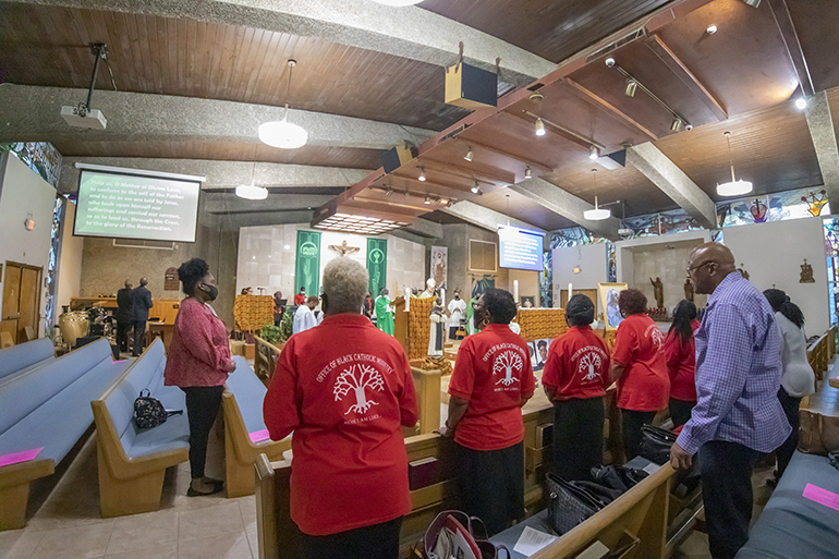 Faithful gathered at St. Bartholomew Church in Miramar pray during the Mass that marked the start of Black Catholic History Month, Nov. 6, 2021. Those wearing red shirts are members of the Archdiocese of Miami's Office of Black Catholic Ministry, which helped organize the Mass.