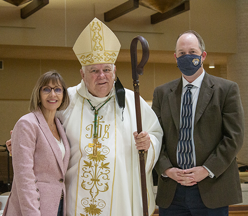 Archbishop Thomas Wenski and Jim Rigg, archdiocesan superintendent of schools, congratulate Maria Barni Hopkins of St. Katharine Drexel Parish in Weston, recipient of the 2021 Esperanza Ginoris Award for exemplifying excellence in catechetical ministry. She has served as a catechist for 14 years.