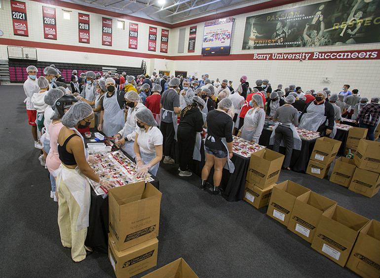 Overview of the Barry University gymnasium and volunteers working to pack 40,000 meals in four hours, Nov. 8, 2021. The meals were to be distributed by Cross Catholic Outreach to the poor in Haiti and South Florida.
