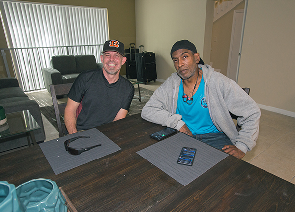 Rodney Grant, left, and Darnell Metcalf pose in their new apartment at Camillus House's Somerville Residence, Nov, 8, 2021.