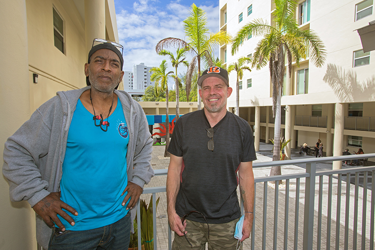 Darnell Metcalf, left, and Rodney Grant are pictured here on a balcony of their new home, Camillus House's Somerville Residence, Nov. 8, 2021.