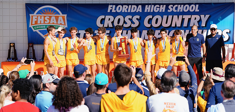 Belen Jesuit's cross-country team pose with their first-place trophy after the state cross-country championships, held Nov. 12, 2021 in Tallahassee. Belen came away with its fifth straight title, and 13th overall.