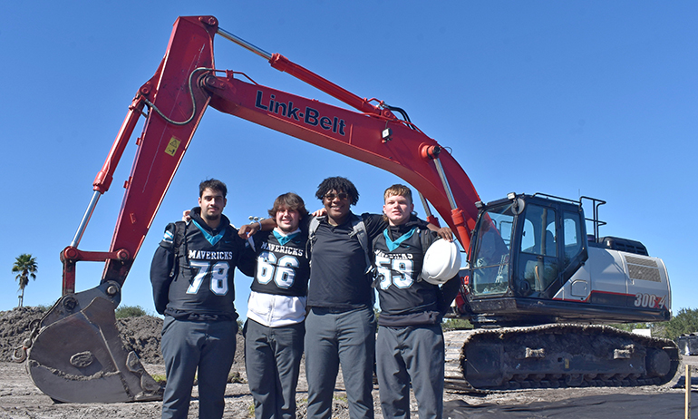 Members of the Mavericks football team attend the groundbreaking Nov. 30, 2021 for a new athletic field at Archbishop McCarthy High School in Southwest Ranches. From left are George Reppas, Colin Kolehma, Kyler Velia and Gunner McGahee.