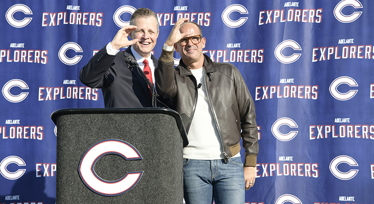 Christopher Columbus alumnus and entrepreneur Marcus Lemonis, right, and the high school's president, Thomas Kruczek, throw up the high school's "C" sign after announcing his $ 10 million donation to his alma mater, Dec. 9, 2021.