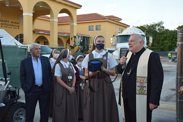 Archbishop Thomas Wenski speaks at the dedication of St. Agnes Academy's new preschool building, Dec. 15, 2021, as Servants of the Pierced Hearts of Jesus and Mary and Ed Easton, co-chairperson of the Building Committee, look on.