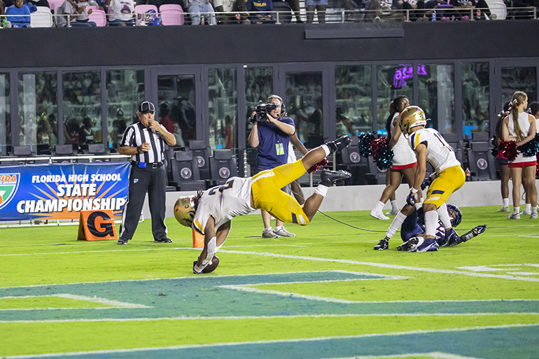 St. Thomas Aquinas running back Anthony Hankerson (2) dives in with the ball to score the school's sixth and final touchdown during the Class 7A State Championship game between Aquinas and Tampa Bay Tech at DRV PNK Stadium in Fort Lauderdale, Dec. 17, 2021. Aquinas won the championship with a final score of 42-14.