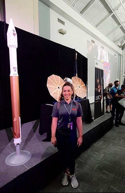 Jupiter bound: Science teacher Yolanda Pineda from Immaculate Conception School in Hialeah poses with models of the rocket and Lucy space probe that were launched by NASA on Oct. 16, 2021 in Cape Canaveral.
