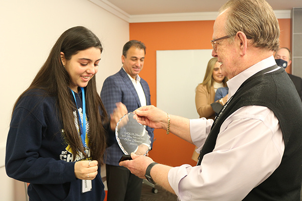 Robert Mulder, assistant principal at St. Thomas Aquinas High School, presents an award to senior Sofia Alvarez Jan. 31, 2022.