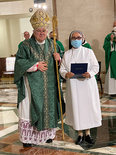 Sister Enith Montero, a member of the Dominicans of the Immaculate Conception from Quito, Ecuador, receives a certificate recognizing her 50 years in religious life during the annual celebration of consecrated life, held this year Feb. 5, 2022 at St. Mary Cathedral, with Archbishop Thomas Wenski presiding.