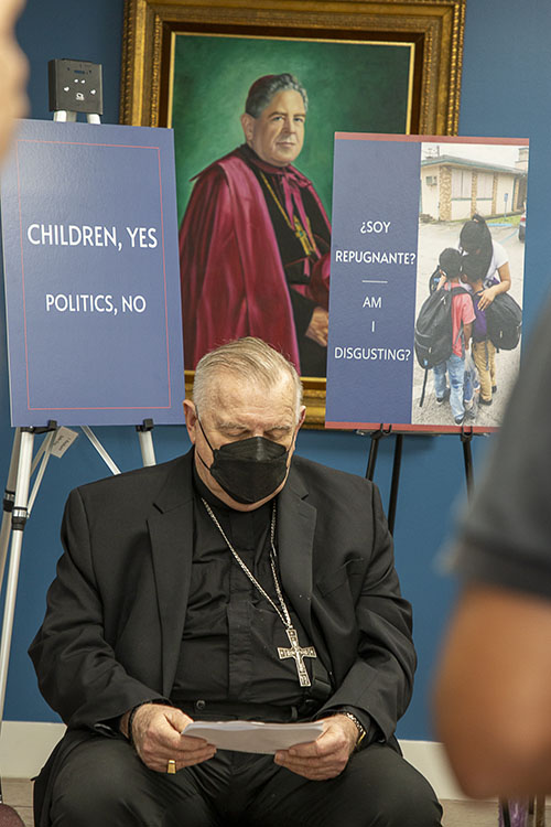 During a press conference held Feb. 10, 2022 in the offices of the Pastoral Center, Miami's first archbishop, Coleman Carroll, seems to be looking upon his successor, Archbishop Thomas Wenski, as the signs proclaim the Archdiocese of Miami's determination to continue sheltering unaccompanied minors just as Archbishop Carroll welcomed the Pedro Pan children in the 1960s.