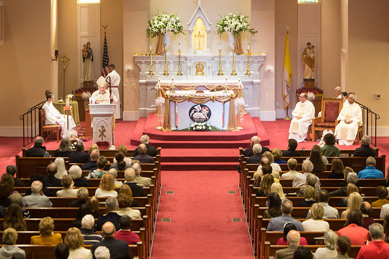 Archbishop Thomas Wenski preaches the homily while celebrating Mass for the 150th anniversary of St. Michael the Archangel Parish in Fernandina Beach, Feb. 20, 2022.