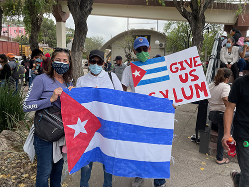 Teresita Gonzalez, Christian service coordinator at Belen Jesuit Prep, poses with some Cuban migrants stuck at the border in Mexico. While taking part in the Kino Border Initiative in November 2021, Belen students walked with migrants protesting Title 42, which closes the border to asylum seekers due to the pandemic.