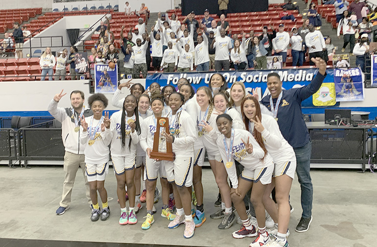 St. Thomas Aquinas' players and coaches celebrate their state championship with their fans after the Raiders' 59-45 victory over Apopka Wekiva in the FHSAA Class 6A girls basketball state-championship game, Feb. 26, 2022, at the RP Funding Center in Lakeland. The Raiders won their second consecutive state title.