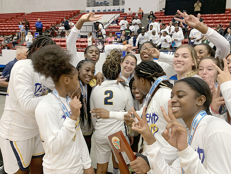 St. Thomas Aquinas players use Mya Williams' No. 2 jersey to display how many titles they've won after the Raiders' 59-45 victory over Apopka Wekiva in the FHSAA Class 6A girls basketball state-championship game, Feb. 26, 2022, at the RP Funding Center in Lakeland. The Raiders won their second consecutive state title.