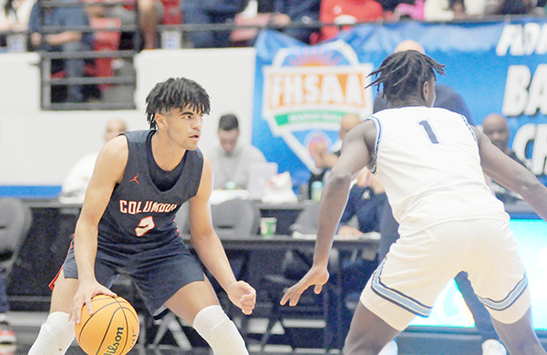 Columbus guard Cayden Boozer, left, looks for an open teammate as Dr. Phillips' Denzel Aberdeen (1) defends during in Columbus' 45-44 victory over defending state champion Dr. Phillips, March 5, 2022, in the FHSAA Class 7A state boys basketball championship game at RP Funding Center in Lakeland.