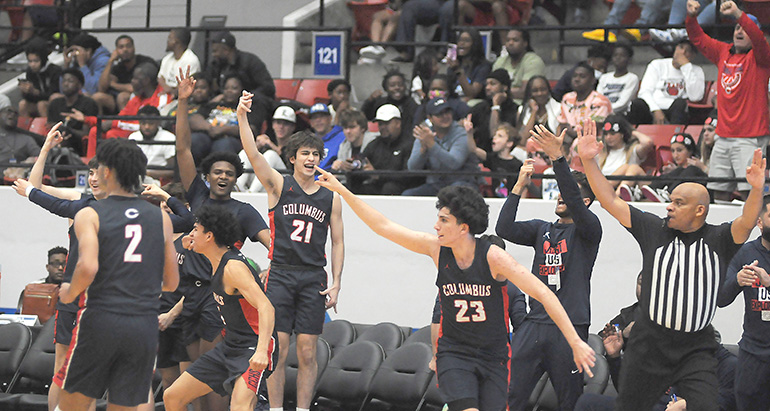 Columbus bench players celebrate after Benny Fragela (23) hit a buzzer-beating 3-pointer at the end of the third quarter of Columbus' 45-44 victory over defending state champion Dr. Phillips, March 5, 2022, in the FHSAA Class 7A state boys basketball championship game at RP Funding Center in Lakeland.