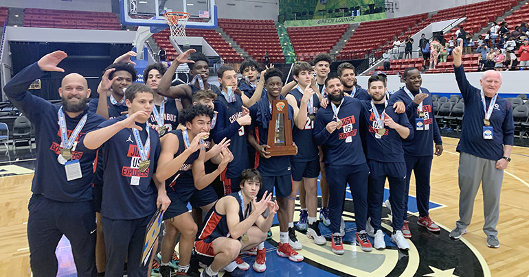 Columbus players, coaches and managers show the Columbus C while taking a team photo after the Explorers' 45-44 victory over defending state champion Dr. Phillips, March 5, 2022 in the FHSAA Class 7A state boys basketball championship game at RP Funding Center in Lakeland. After Dr. Phillips won its first title last year, Columbus won its first title this year.