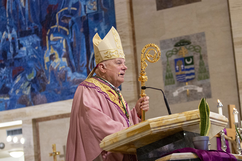 Archbishop Thomas Wenski preaches at the Mass he celebrated March 26, 2022, the Fourth Sunday of Lent, at St. Mary Cathedral with about 100 parish representatives for the global 2021-23 Synod. They had gathered for an assembly summarizing the feedback gathered during the listening sessions at the churches and archdiocesan entities during the past few months.