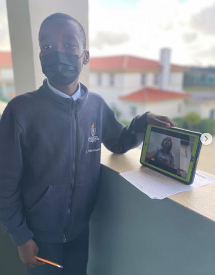 Jeremiah Petit Homme, a student from St. Mary Cathedral School in Miami, interviews Valentino from St. Louis Covenant School in Pinecrest via Google Meet on their tablets. Fifth-graders and their classmates at both schools teamed up to read "Wonder" by R.J. Palacio.