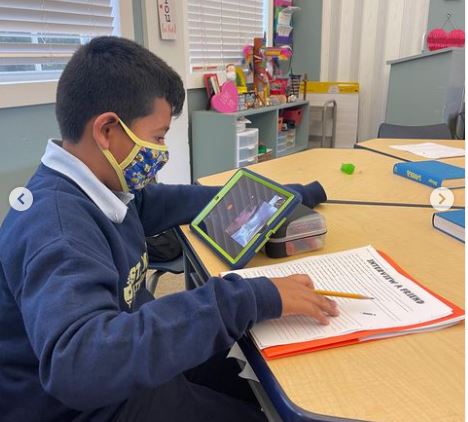 Lester Hernandez, a student from St. Louis Covenant School in Pinecrest, interviews Claranjah Pierre from St. Mary Cathedral School in Miami via Google Meet on their tablets. Fifth-graders and their classmates at both schools teamed up to read "Wonder" by R.J. Palacio.
