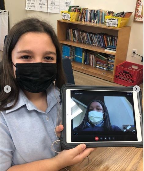 Carolina Tarafa, a student from St. Louis Covenant School in Pinecrest, interviews Claranjah Pierre from St. Mary Cathedral School in Miami via Google Meet on their tablets. Fifth-graders and their classmates at both schools teamed up to read "Wonder" by R.J. Palacio.