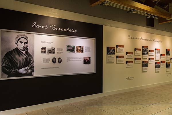 An inside wall of Our Lady of Lourdes Parish Hall tells the story of St. Bernadette, her life and apparitions of the Virgin Mary in Lourdes.