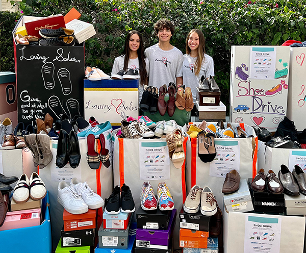 The Inguanzo siblings pause outside their home in Miami Lakes, headquarters of the Loving Soles collection drive for shoes for the homeless. From left are Sophia, Christopher and Sophia's twin, Susanna.