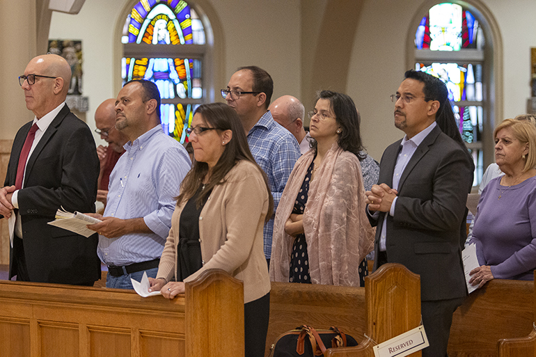 Parish representatives pray during the Mass that followed the Synod assembly, March 26, 2022. Archbishop Thomas Wenski joined about 100 parish representatives for an assembly summarizing the feedback gathered during the listening sessions for the Synod on Synodality at the churches and archdiocesan entities during the past few months.