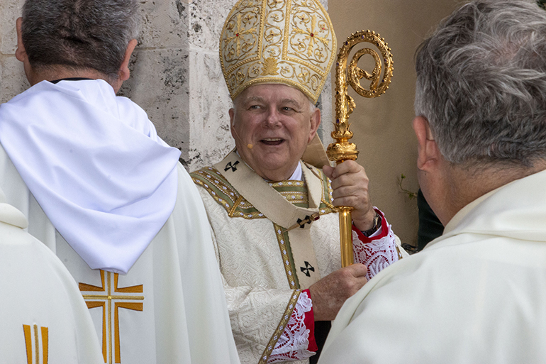 Archbishop Thomas Wenski greets archdiocesan priests as they enter St. Mary Cathedral for the chrism Mass, April 12, 2022. More than 200 priests and five bishops gathered for the annual Mass, celebrated on the Tuesday of Holy Week. Eighteen priests were honored for marking 70, 60, 50 and 25 years of ordination, and the archbishop also was recognized as this marks his 25th year as a bishop.