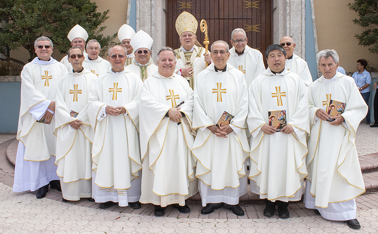 Jubilarians and concelebrating bishops pose for a photo with Archbishop Thomas Wenski after the chrism Mass. From left, rear: Bishop Fernando Isern, Bishop Silvio Baez, Archbishop Wenski, Jesuit Father Alberto Garcia, Jesuit Father Eduardo Barrios; middle row, Father Fernando Orejuela, AIC, Father Juan Lopez, Bishop Enrique Delgado; front row: Father Jose Luis Paniagua, Msgr. Jose Luis Hernando, Father Juan Sosa, Father Joaquin Rodriguez, Father Yunping Peter Lin and Father Sean Mulcahy.