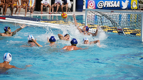 Belen goalie Bryan Weglarz reaches for the ball during Belen Jesuit Prep's championship water polo match April 23, 2022 in Miami. The Wolverines defeated Orlando's Dr. Phillips High School 17-13 to win the FHSAA state championship and complete an undefeated season.