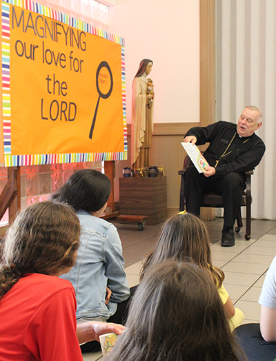 Archbishop of Miami Thomas Wenski reads "The Gift That I Can Give," written by Kathy Lee Gifford, to students from Blessed Trinity School in Miami Springs on April 29, 2022. The reading concluded the Enchanted Book Fair, a week-long literary celebration at the school.