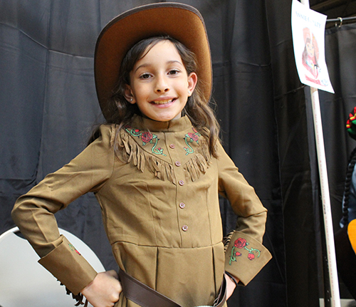 Giuliana Aja portrays Annie Oakley, the American sharp shooter and star of Buffalo Bill's Wild West Show at the Third Grade Wax Museum at St. Louis Covenant School in Pinecrest, April 29, 2022.