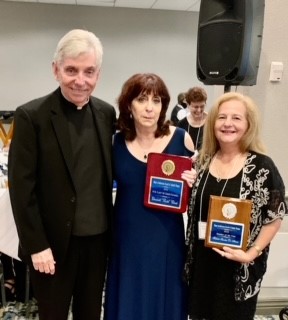 Father Michael Greer, spiritual director of the Miami Archdiocesan Council of Catholic Women, poses with the two members honored at this year's convention, held April 29-May 1: Elizabeth (Bette) Clark from St. Andrew Parish in Coral Springs, center, and Fabiola Sánchez De Armas from Good Shepherd Parish in Miami.