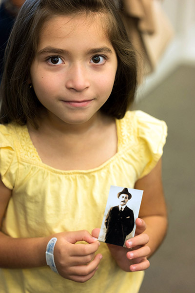 Isabela Granado, 6, of St. Katharine Drexel Parish in Weston, holds a prayer card of Blessed José Gregorio Hernández, a Venezuelan medical “doctor of the poor” whom Pope Francis beatified last year. Hernandez was born in 1864 and his relics were on display May 1, 2022 at the South Florida parish.
