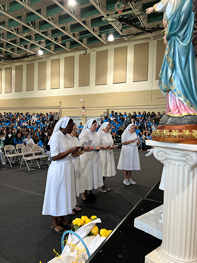 Salesian Sisters renew their vows in front of assembled students and staff at Immaculata-La Salle High School in Miami. From left: Sister Myriam Meus, Sister Mary Rinaldi, who was visiting, Sister Katie Flanagan, Sister Eileen Tickner and Sister Kim Keraitis, principal.