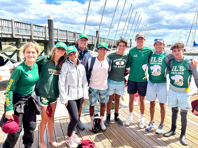 Immaculata_La Salle's sailing team pose for a photo with their coach, Maru Urban, after their winning performance at the SAISA Team Racing District Championship at the College of Charleston in South Carolina the weekend of May 7, 2022.