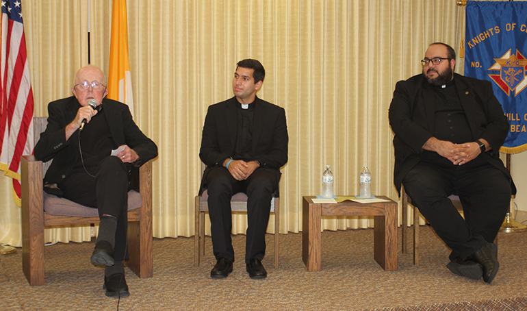 Father Anthony Mulderry, pastor emeritus of St. Gabriel Parish in Pompano Beach and former chaplain and longtime supporter of the Serra Club of Broward County, reflects on his priesthood shortly after he is presented the St. Junipero Serra Excellence Award May 14, 2022, at a ceremony organized by the Serra Club of Broward County. Shown at his side is Deacon Gustavo Santos, a seminarian for the Archdiocese of Miami, and Father Matthew Gomez, vocations director of the archdiocese.