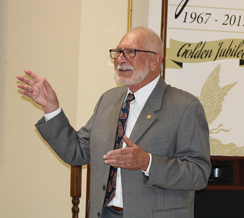 Malcolm Meikle greets participants May 14, 2022, to a Serra Club of Broward County event honoring Father Anthony Mulderry, pastor emeritus of St. Gabriel Parish in Pompano Beach and former chaplain for the club.