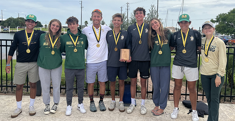 Immaculata-La Salle's sailing team and their coach, Maru Urban, in white, pose with their medals after winning their first national championship, the Baker Team Racing National Championship, in Houston, Texas, the weekend of May 21-22, 2022.