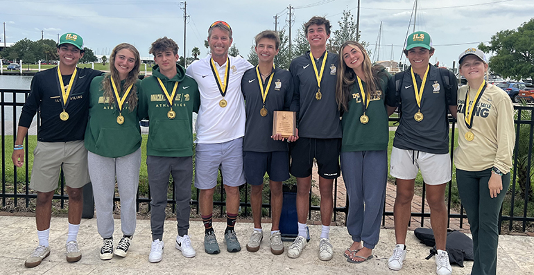 Immaculata-La Salle's sailing team and their coach, Maru Urban, in white, pose with their medals after winning their first national championship, the Baker Team Racing National Championship, in Houston, Texas, the weekend of May 21-22, 2022.