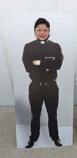 Damian del Gallego, 6, a parishioner at Our Lady of Guadalupe, poses with a cutout of a "future priest" found at the Vocations Office booth during the Family Faith Fest, celebrated at Our Lady of Guadalupe, Doral, June 25, 2022.