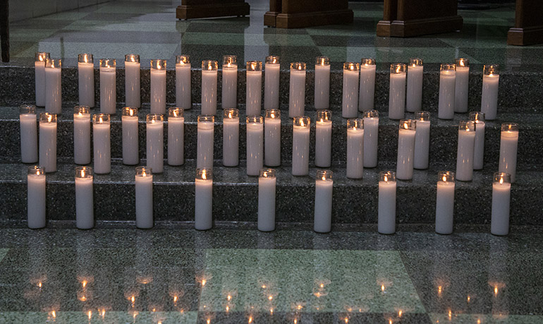 98 candles: 49 on each side of the altar, served as a reminder of those lost in the collapse of Champlain Towers  South on June 24, 2021. St. Joseph, the church nearest the collapse site, marked the one-year anniversary of the Surfside tragedy with a Mass and the lighting of 98 candles for each of those who perished, June 24, 2022.