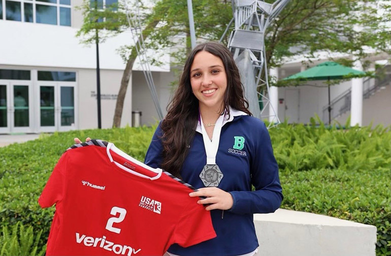 Amanda Sumalla, who will be a junior this fall at St. Brendan High School, holds up her Team USA jersey. She is representing the U.S. at the Women's Junior World Championship in Slovenia from June 22 to July 3, 2022.