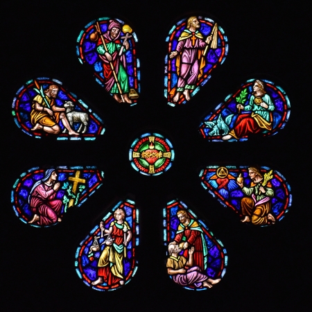 The rose petal window shows several biblical scenes. At center is the Sacred Heart of Jesus.