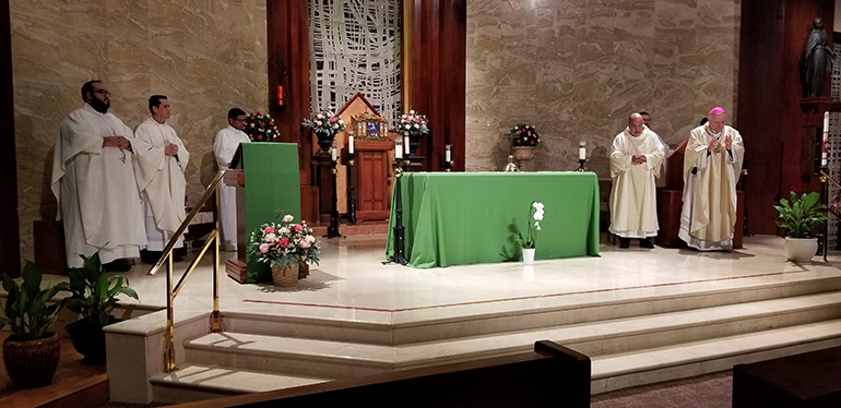 Archbishop Thomas Wenski celebrates a Mass, July 26, 2022, marking the feast of Sts. Joachim and Anne as well as the 45th anniversary of the death of Miami's founding bishop, Coleman Carroll. At left, are Father Matthew Gomez, archdiocesan vocations director; Father Juan Carlos Salazar, administrator of St. Martha Parish; and seminarian Milton Martinez. Standing next to him is Deacon Victor Pimentel, director of the Permanent Deaconate Office.