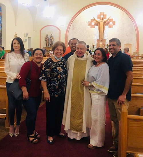 Father Juan Lopez poses with some of his parishioners after celebrating 60 years of priesthood at the parish where he has served for 42 of those years, Sts. Peter and Paul in Miami. The celebration took place June 24, 2022.