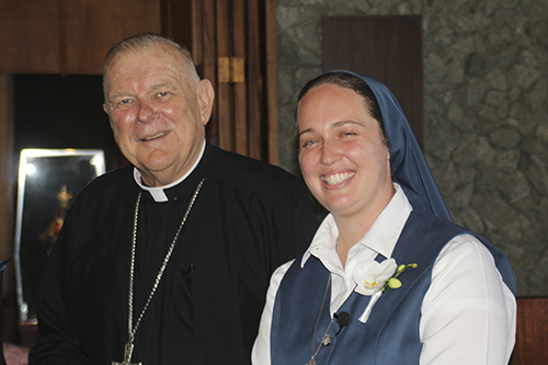 Archbishop Thomas Wenski talks to Sister Carly Paula Arcella before her final profession as a Daughter of St. Paul July 16, 2022, at her home parish of St. Paul the Apostle in Lighthouse Point.