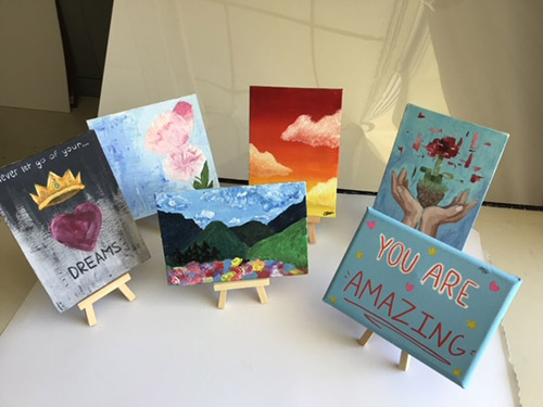 Canvases created by St. Brendan High School art students are displayed at the Christine E. Lynn Rehabilitation Center at Jackson Medical Center's main campus.